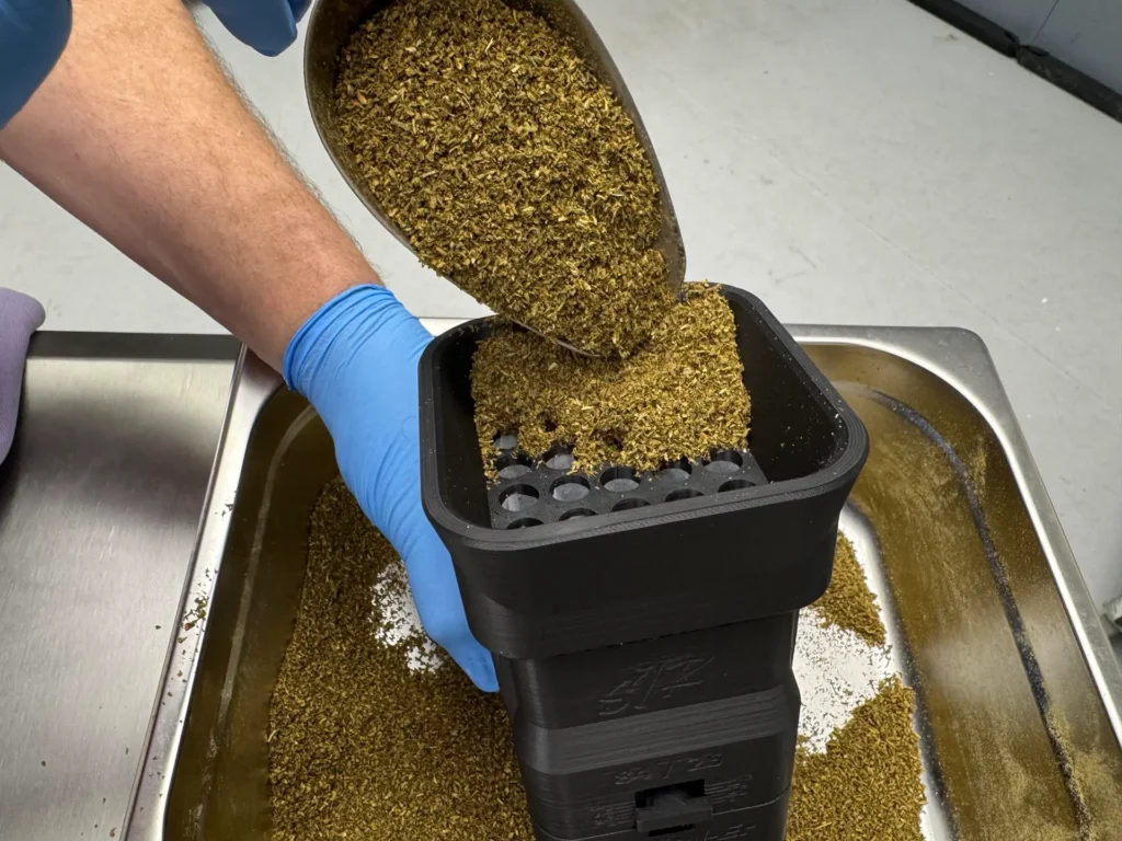 Fill each pod with the ground cannabis