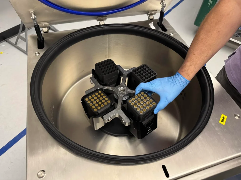 Insert the loaded pods into the machine